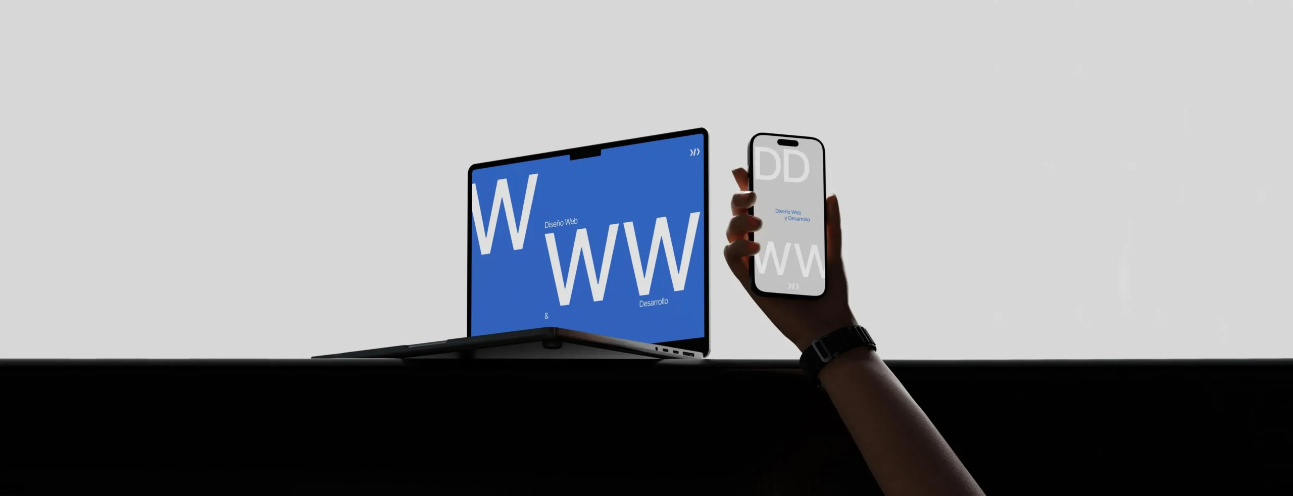 Portátil y mano sosteniendo un móvil mostrando el servicio de diseño web y desarrollo de DonDigital con tipografía destacada, fotografía realizada por DonDigital.