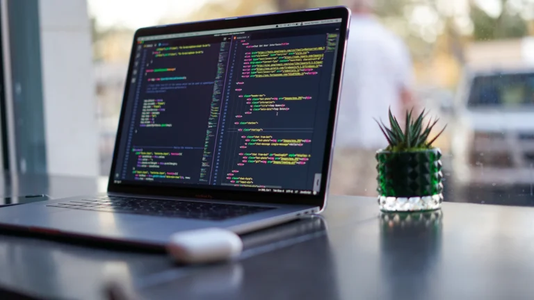 Portátil con código en pantalla durante el mantenimiento de una web